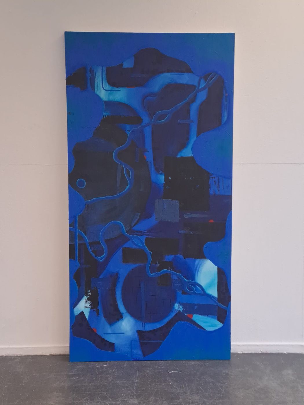 Growing pain. Large blue painting with dark abstract shapes